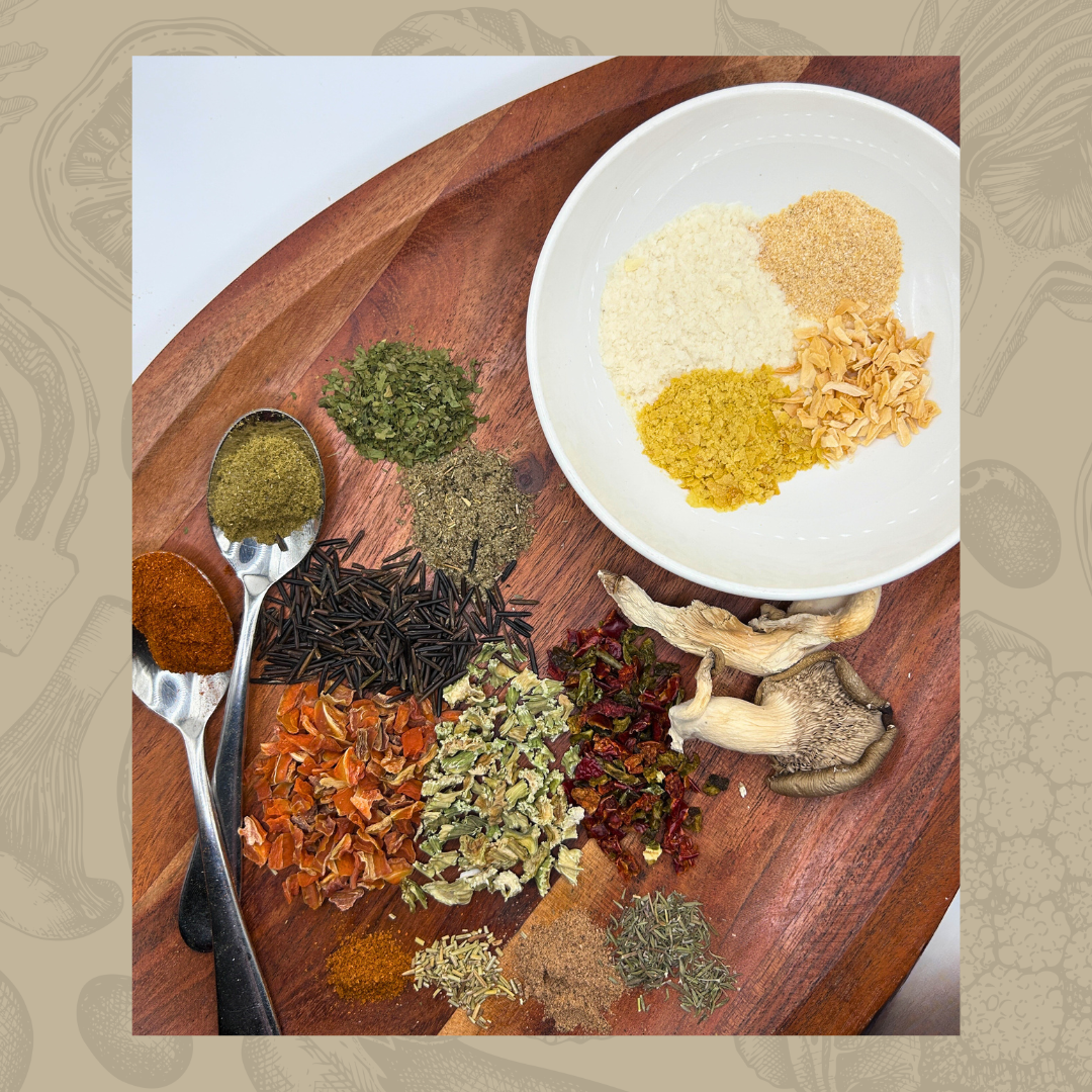 Spices and herbs used for Wild Rice & Mushroom Bits Soup on a wooden board with a white plate of mixed spices.