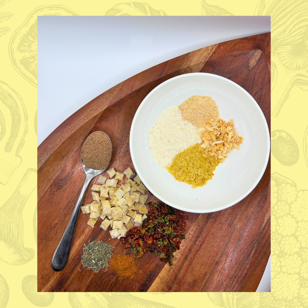 Spices and herbs for a vegan potato soup on a wooden board with a white plate