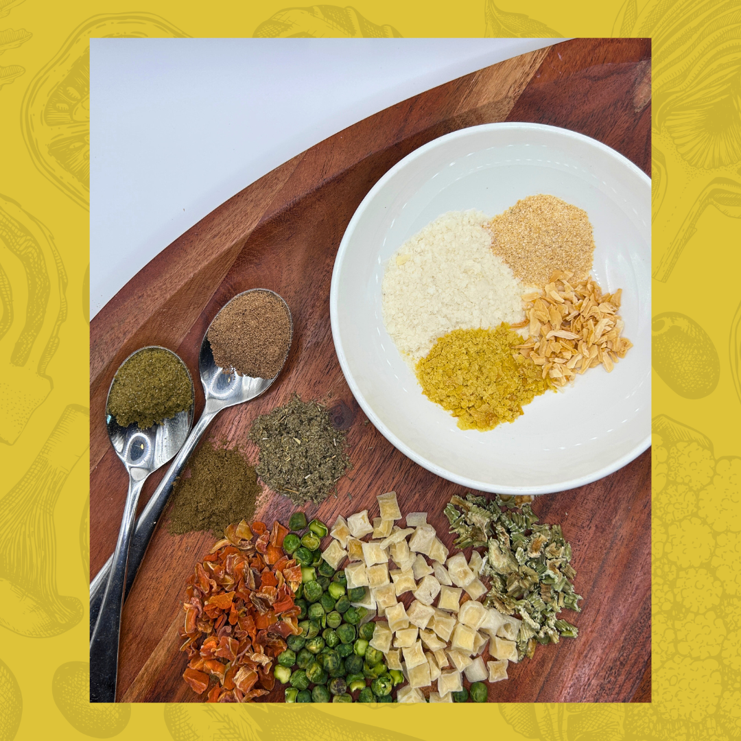 Spices and seasonings for creamy pot pie soup on a wooden board with a white plate and spoons.